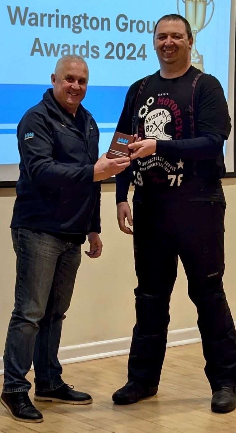 Baz receiving Associate of the Year 2024 award at Warrington Group Awards